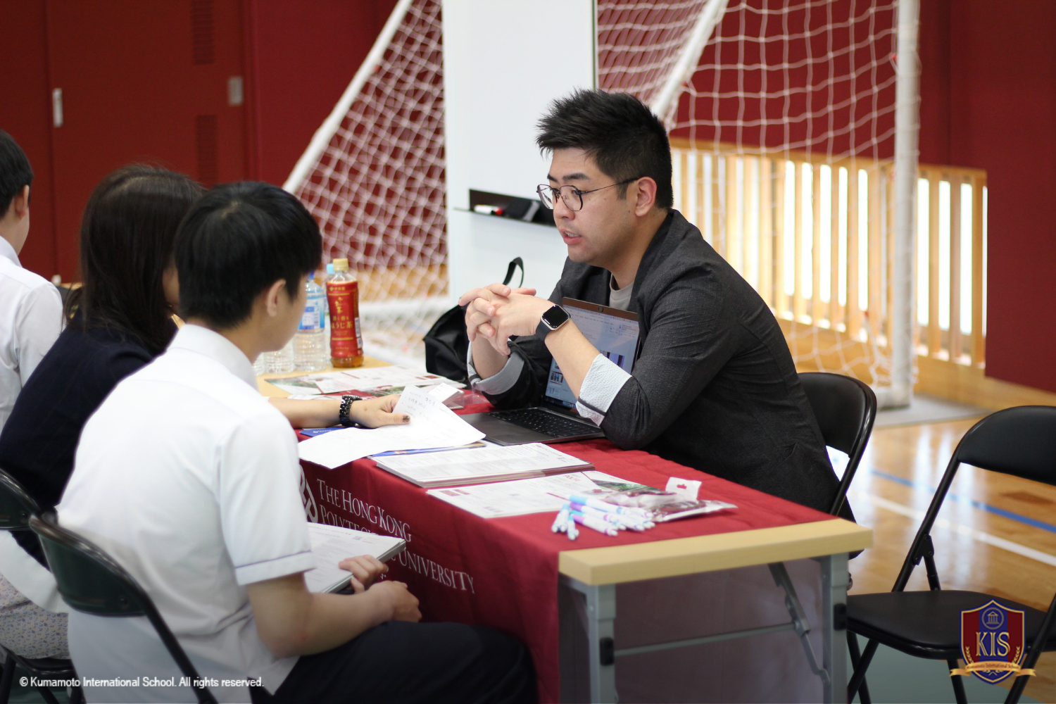 University representative explaining to a student and parent.